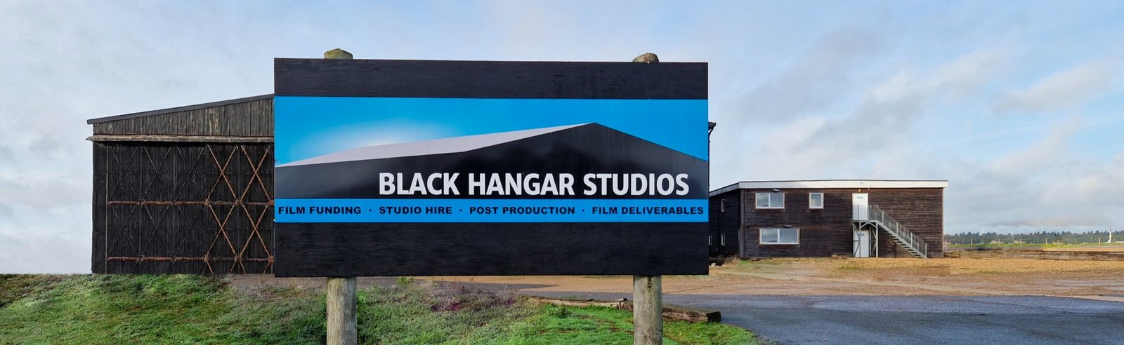 Black Hangar Studios sign in front of the hangar on Lasham Airfield