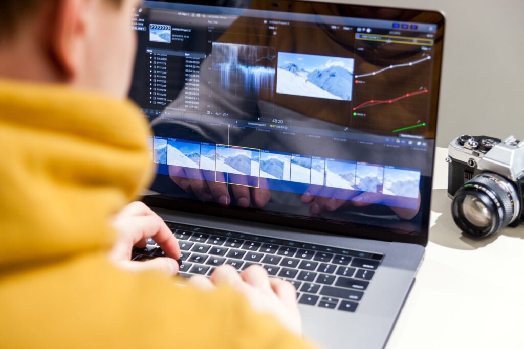 Editor reviewing footage on a laptop